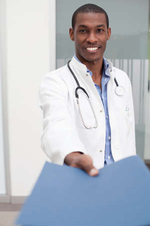 Doctor handing over paperworkの写真素材