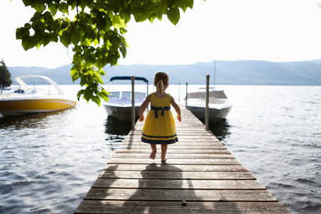 Female toddler exploring pier, Silver Bay, New York, USAの写真素材