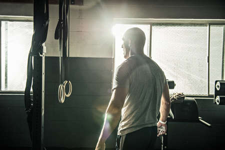 Mid adult man preparing to train in gymnasiumの写真素材