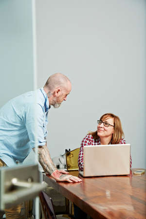 Office colleagues using laptop