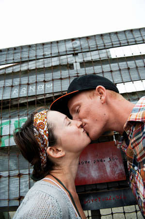 Young couple kissing with eyes closedの写真素材