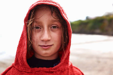 Portrait of girl in red hooded topの写真素材