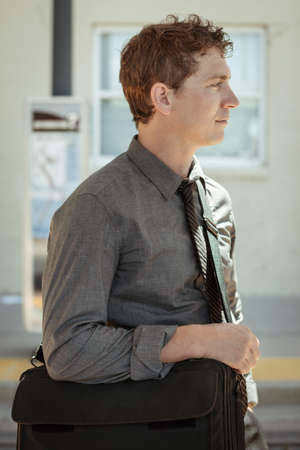 Mid adult office worker waiting at train station