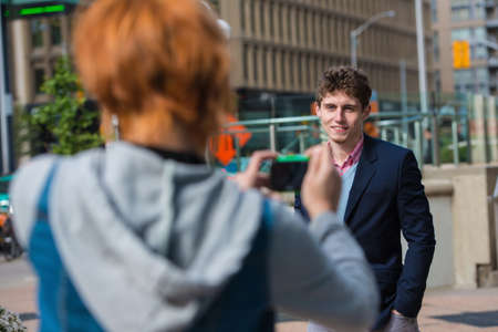 Young woman photographing boyfriendの写真素材