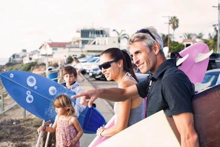Family at coast with surfboards, Encinitas, California, USAの写真素材