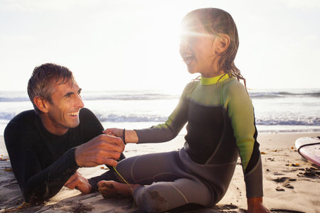 Father and daughter holding hands on beach, Encinitas, California, USAの写真素材