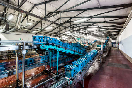 Crates of mineral water on bottling plant conveyor belt