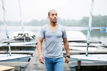 Young man on jetty in marina