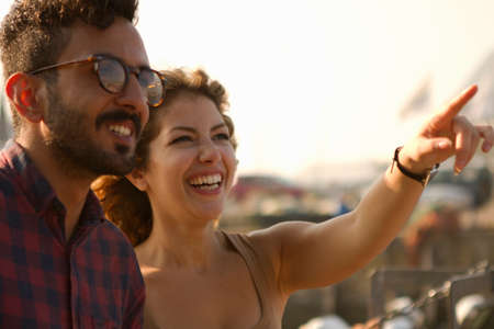 Young couple laughing, woman pointingの写真素材