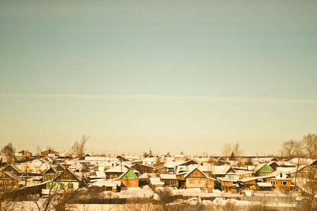 Village with snow on rooftops, Russiaの写真素材
