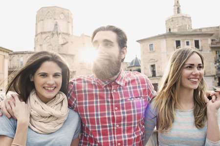 Three young tourists, Plaza de la Virgen, Valencia, Spain