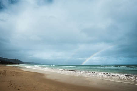 Coastal view with double rainbow, Victoria, Australiaの写真素材
