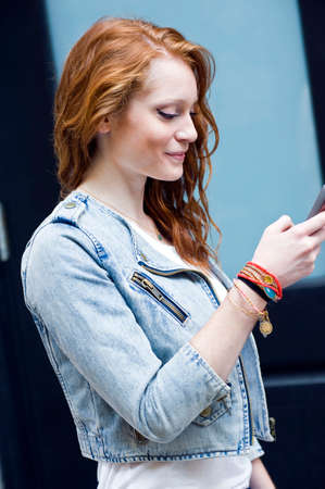 Portrait of young woman using mobile phoneの写真素材