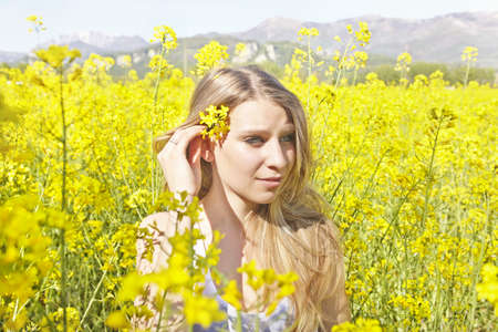 Young woman with yellow flower in hair, portrait