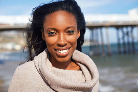 Portrait of smiling young woman at beach, Malibu, California, USA