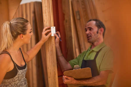 Carpenters looking at piece of wood