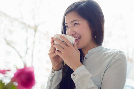 Woman relaxing with cup of tea