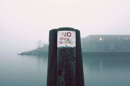 Sign on waterfront fencepost, Red Hook, Brooklyn, New York, USAの写真素材