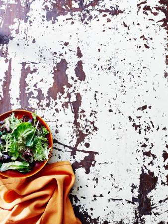 Still life of salad leaf and orange napkinの写真素材