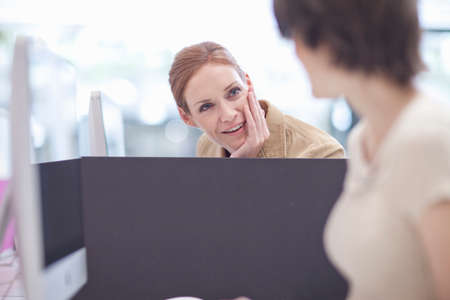 Female colleagues talkingの写真素材