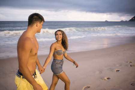 Romantic young couple strolling on Ipanema Beach, Rio de Janeiro, Brazil