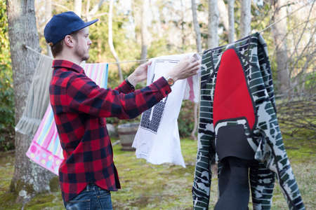 Mid adult man hanging out laundry in garden