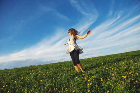 Young woman standing in fieldの写真素材