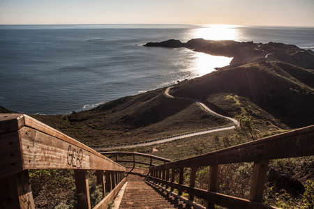View of coastal staircase and sea at sunset, San Francisco, California, USAの写真素材