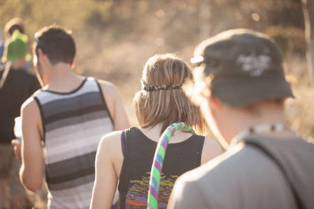 Rear view of small group of young people out walkingの写真素材