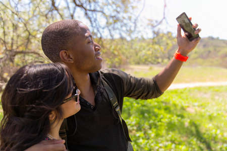 Young couple posing for self portrait in park