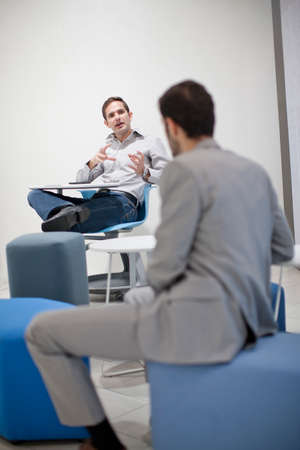 Male colleagues talking in office