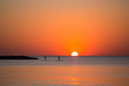 Paddleboarders at sunset, Tel Aviv, Israel