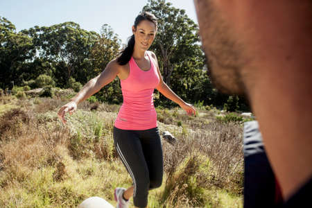 Man looking at female jogger balancing