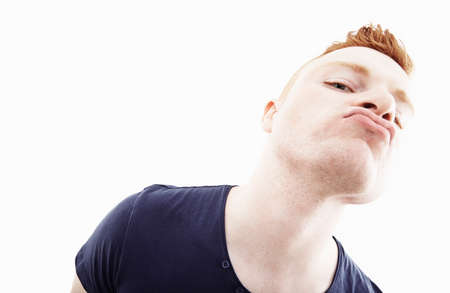 Studio portrait of young man pulling a face