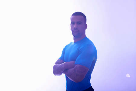 Studio portrait of muscular sportsman with arms foldedの写真素材