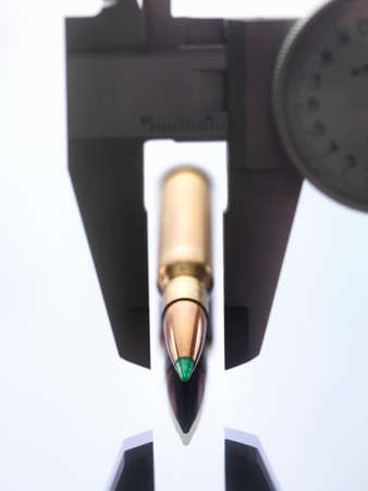 Calipers measuring bullet for forensic investigationの写真素材