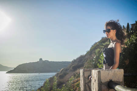 Young woman looking at view of the seaの写真素材