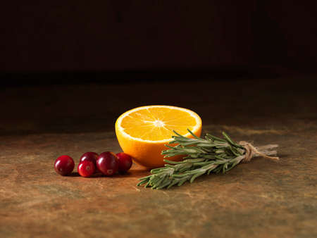 Festive Christmas ingredients of orange, cranberry and rosemary for stuffing balls with port cranberry sauce centresの写真素材