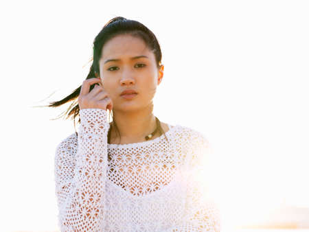 Portrait of young woman on beach in sunlight, Port Melbourne, Melbourne, Victoria, Australiaの写真素材