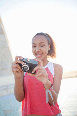 Teenage girl preparing cameraの写真素材