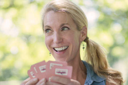 Mature woman playing cardsの写真素材