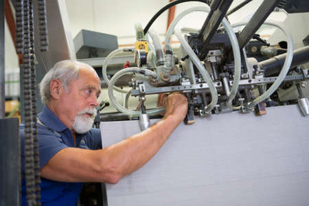 Factory worker working machinery