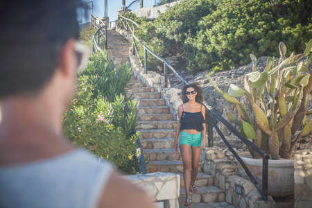 Young woman coming down stepsの写真素材
