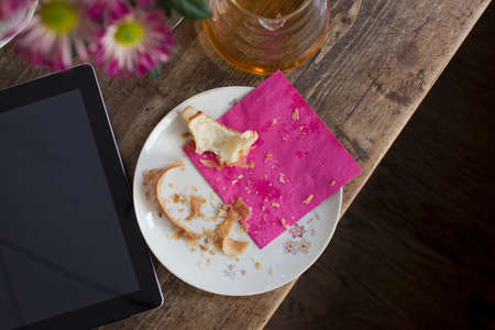 Plate with crumbs and digital tabletの写真素材