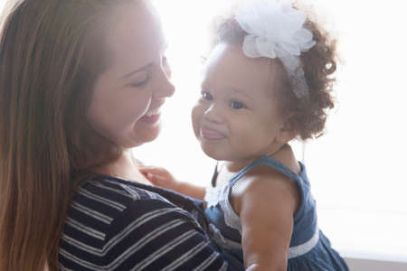 Mother holding baby daughterの写真素材