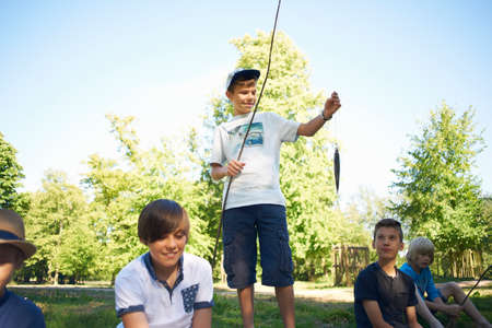 Boy holding fishing net with fish