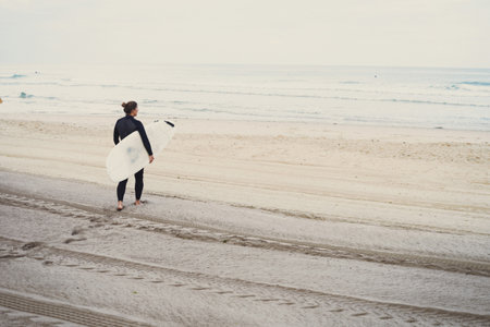 Surfer with surfboard on beach, Lacanau, Franceの写真素材