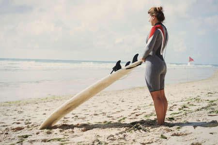 Surfer with surfboard on beach, Lacanau, Franceの写真素材