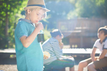 Young boy having lunch in parkの写真素材