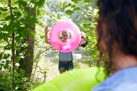 Hikers in forest with inflatable ringの写真素材